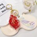 Detail of red shell keychain with white pearl and holographic PVC strap on display - Leather Strap + Small Conch + Pearl / Red