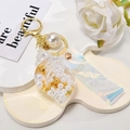 Creative conch keychain with pearls and holographic strap on a white background - Leather Strap + Small Conch + Pearl / White