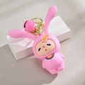 Pink silicone bunny keychain with star detail and matching bell on white platform - Pink With Bell