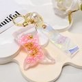 Detail of mermaid tail liquid keychain with pink pearls and iridescent holographic strap - Shiny Cord + Mermaid + Pearl / Pink