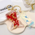 Creative mermaid tail keychain with red pearls and laser PVC strap on white background - Shiny Cord + Mermaid + Pearl / Red