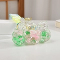 Detail of creative motorcycle bottle keychain with floating stars and colorful liquid sand - Fruit Green