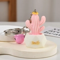 Detailed close-up of a pink resin cactus keychain with a white Smile pot and pink bell - Cactus Shape / Pink Smile