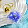 Portachiavi caramella con sabbie mobili viola, anello dorato e paillettes a cuore mobili - Cuscino Decorativo Viola