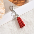Detail shot of a vivid red faux suede tassel pendant with a silver lobster clasp - Lobster Clasp / Red
