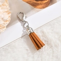 Detail of caramel faux suede tassel pendant with silver metal cap and lobster clasp - Lobster Clasp / Ginger Yellow