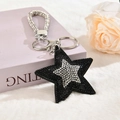 Portachiavi a stella scintillante con strass neri e cinturino decorato con cristalli - Chiusura Argentata / Nero