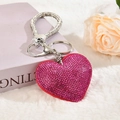 Close-up of a pink heart-shaped rhinestone keychain on white fluffy plush background - Keychain [Rose Red]