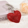 Close-up of heart-shaped keychain with red rhinestones on soft white plush fabric - With Phone Patch [Red]