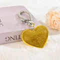 Close-up of a sparkling heart keychain with yellow rhinestones on a white fur backdrop - With Phone Patch [Lemon Yellow]