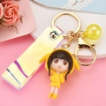 Cute yellow resin girl keychain with a holographic strap and glitter ball pendant charm - Lemon Yellow