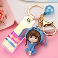 Creative girl doll keychain in blue creature costume with holographic strap and blue bead - Blue
