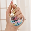 Cute blue whale liquid quicksand keychain with macaron beads and a large pearl accessory - Jelly Bean Blue