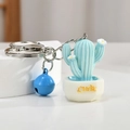 Miniature blue resin cactus keychain with white pot, blue bell and yellow Luck text - Blue Luck