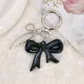 Chic black acrylic bow keychain with silver spring clasp and woven bow charm - Black