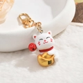 Cute white Maneki Neko keychain with golden ingot and red Daruma on white plush - Lucky Cat (Wealth Ingot)