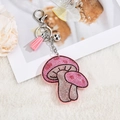 Pink mushroom keychain detail with sparkling rhinestones and matching leather tassel - Tassel Style / Pink