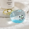Floating panda keychain with blue liquid and glitter inside a clear round charm - Single Hook Peach / Blue