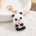 Cute panda silicone keychain holding a pink phone with golden metal lobster clasp - Pink Bear