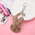 Sparkling rhinestone rabbit keychain with light brown suede finish and tassel detail - Ginger Yellow