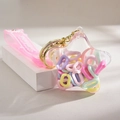 Stern-Schlüsselanhänger mit flüssigem Sand, pinkem Armband und bunten Ringen - Macaron Ringfüllung Stil