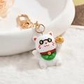 Cute lucky cat keychain with black sunglasses and golden sycee on white plush background - Lucky Cat (Cool Sunglasses)