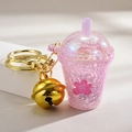 Pink glitter milk tea cup keychain with golden bell and floral pattern for bags - Bell Style [Purple]