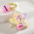 Acryl-Schlüsselanhänger in Sternform mit bunten Ketten und rosa Glockenanhänger - Glocken-Macaron-Mix Stil