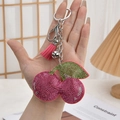 Pink rhinestone cherry keychain with tassel and silver bell held in hand - Silver Buckle + Cherry Tassel / Cherry Rose Red