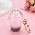 Detail of creative bubble tea keychain with pink liquid and gold moon clasp on a floral set - Moon Buckle + Milk Tea Cup / Pink