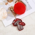 Sparkling mushroom keychain featuring red faux fur pompom and red crystal charm - Fur Ball Style / Red