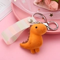 Detail of orange flocked dinosaur keychain with striped ribbon strap and metal hook - Yellow