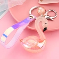 Detail of pink translucent swan keychain with iridescent wrist strap and silver metal ring - Orange