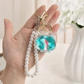 Creative dolphin fish tank keychain with blue liquid, sand, and white pearl strap - Fish Tank Shape - Pearl Chain & Buckle Style