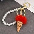 Detail of red plush ice cream keychain with white faux pearls and gold metal lobster clasp - Pink