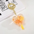 Yellow heart liquid sand keychain with cartoon dog and golden metal ring for bags - Heart Lollipop (Orange)