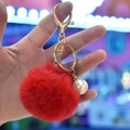 Red faux rabbit fur pom pom keychain with gold lobster clasp and pearl charm accessory - Red