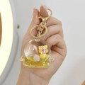 Cinnamoroll liquid sand keychain with yellow doll, glitter, and pearl in penguin shell - Mini Fan (Lemon Yellow)