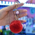 Faux rabbit fur keychain with red pompom, mini bottle, and golden heart clasp - Red
