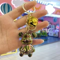 Detailed macro view of an iridescent electroplated bear keychain with a golden bell and ring - Light Gold Buckle + Bear + Bell / Gray
