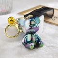 Close-up of holographic bear keychain with golden lobster clasp and black rubber strap - Strap Buckle + Bear + Bell / Gray