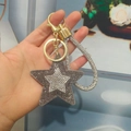 Star-shaped rhinestone keychain with dark gray crystals and a golden woven handle - Light Gold Buckle / Gray