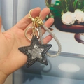 Star-shaped rhinestone keychain in black with gold clasp and sparkling hand strap - Light Gold Buckle / Gunmetal