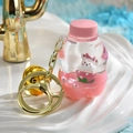 Portachiavi rosa con bottiglia di liquido, orsetto bianco e campanellino d'oro carino - Coniglio in Bottiglia di Soda