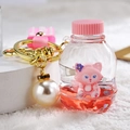 Cute liquid sand keychain featuring a pink fox doll in a red fluid bottle with white pearl - Pink Fox Bottle