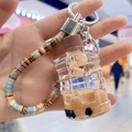 Brown bubble tea cup keychain with cute bear floating in acrylic liquid bottle - Bucket Style (Beaded Rope)