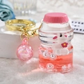 Pink liquid quicksand keychain with cute rabbit doll and golden metal ring charm - Bunny Yogurt Bottle