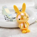Macro shot of yellow iridescent bunny keychain with a translucent gradient wrist strap - Lemon Yellow
