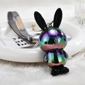 Detail of gradient metallic rabbit keychain with iridescent wrist strap on white tray - Gray