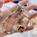 Brown milk tea cup liquid keychain with a cute bear and pearl decor charm - Square Bottle Style (Beaded Rope)